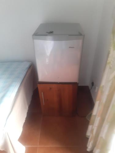 a small room with a bed and a wooden cabinet at Ella floating view in Ella
