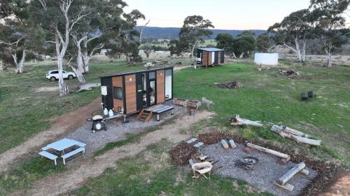 an aerial view of a tiny house in a field at Clover at Lexington Park by Tiny Away in Tarlo
