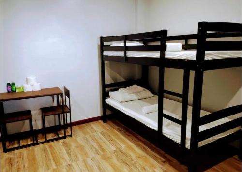 two bunk beds in a room with a wooden floor at Bethany's Point in Oslob