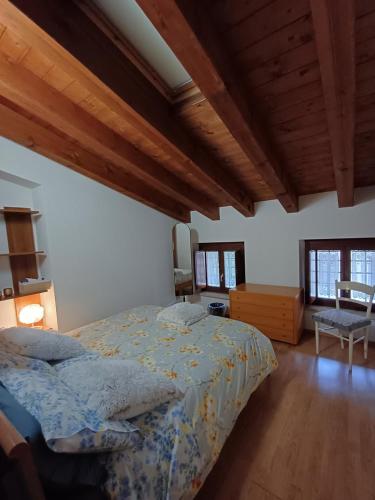 a bedroom with a bed and a wooden ceiling at Splendida Mansarda, aria condizionata "ALLE MURA DEL CASTELLO 2 Stefano e Paola Marchesini" in Gorizia
