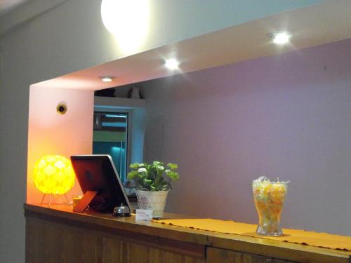 a mirror above a desk with a laptop on it at Hostal Santa Catalina in Seville