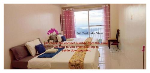 a room with a bed and a window with avertisement at SMDC Tagaytay Taal Lake Condo Cook Netflix No Balcony No Free Parking Contact to Confirm in Tagaytay