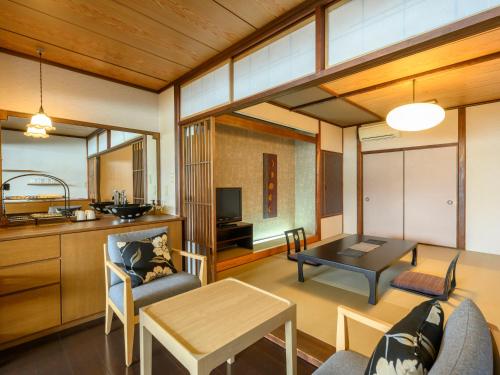 a living room with a kitchen and a dining room at KAMENOI HOTEL Nachi Katsuura Kumano Kodo in Nachikatsuura