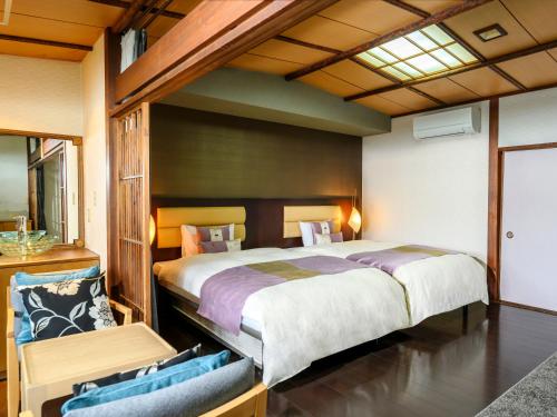 a bedroom with a large bed in a room at KAMENOI HOTEL Nachi Katsuura Kumano Kodo in Nachikatsuura