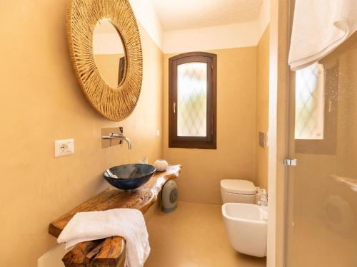 a bathroom with a sink and a mirror at Luxe Côte Stay- Elegant Villa in Porto Cervo