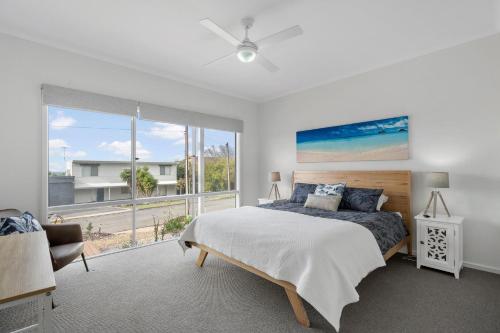 a bedroom with a bed and a large window at 7 Passatt St, Encounter Bay in Encounter Bay
