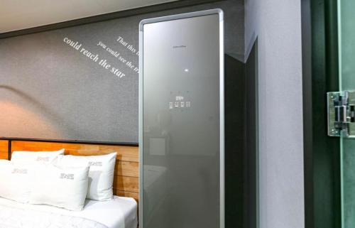 a glass door leading to a bed in a room at The Sharp Hotel in Changwon