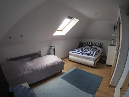 a bedroom with two beds and a skylight at Ferienhaus Gerda in Osteel
