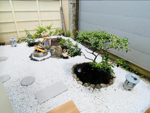 a garden with a bonsai tree and some rocks at M102Near Nagoya Station Machiya Max of 8 people in Chiharachō