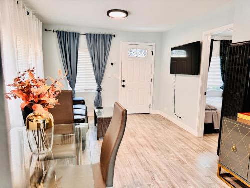 a dining room and living room with a glass table at Walk To Americana on Brand. in Glendale