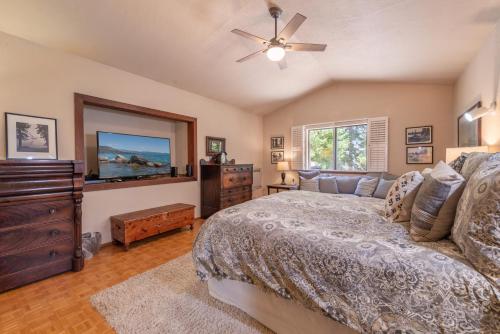 a bedroom with a bed and a dresser and a tv at Tahoe City 4BR 4 Full Bathroom Home Near Palisades Close to Town in Tahoe City