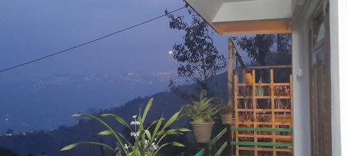 a room with a window with a view of a mountain at Hamro Ghar Farmstay in Darjeeling