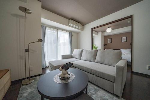 a living room with a couch and a table at Norwegian Wood in Kita-sanjō