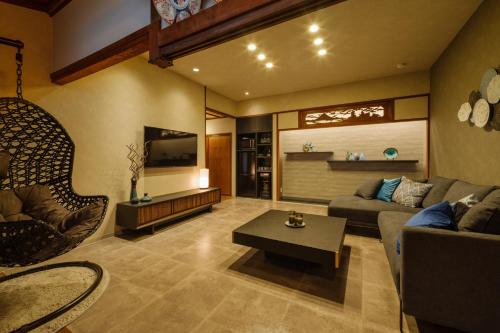 a living room with a couch and a table at UMI-IRO〜うみいろ下関〜 in Shimonoseki
