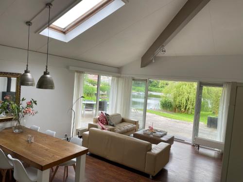 a living room with a couch and a table at StarVilla M in Makkum