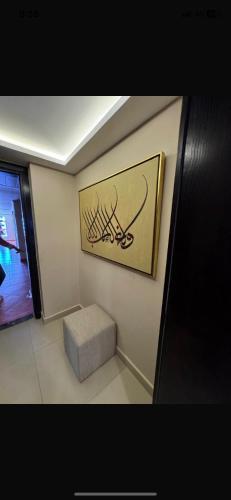 a room with a picture on the wall and a bench at Executive Royal Tower Apartments - Sky Lounge in El Alamein