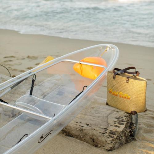a plastic container sitting on the beach with a bag at Hotel Villa AoKhanom Beachfront in Khanom