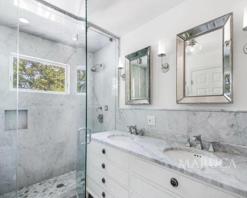a bathroom with a sink and a glass shower at Villa KeyLime in Sag Harbor