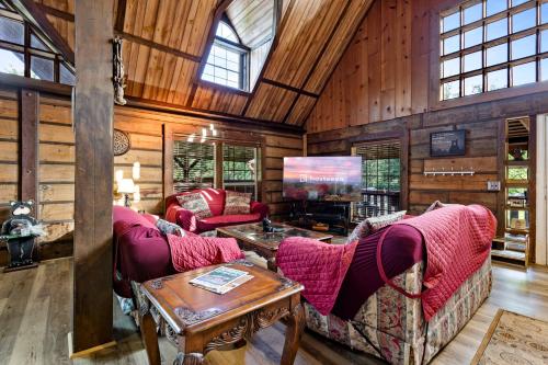 a living room with two couches and a tv at Hillbilly Highrise in Sevierville