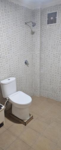 a bathroom with a toilet and a shower at Rinjani Trekking Center in Senaru