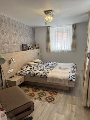 a bedroom with a bed and a chandelier at Brick Wall in Sibiu