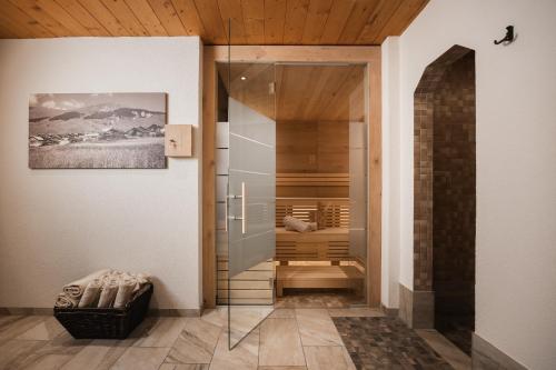 a walk in shower in a room with a glass door at Appartements Markus in Fiss