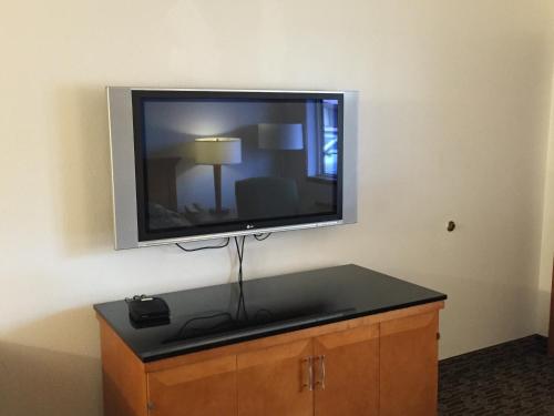 a flat screen tv on a wall in a room at Sunshine Motel in Fife