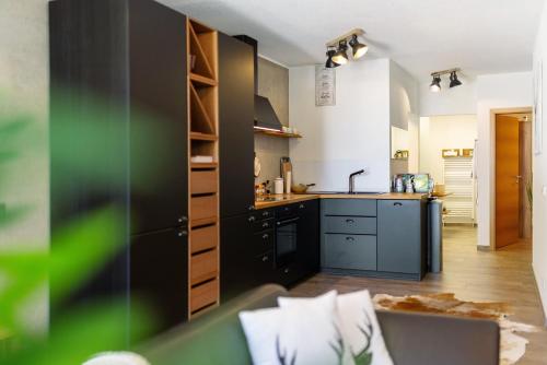 a kitchen with black cabinets and a counter top at Albchalet in Rosenfeld
