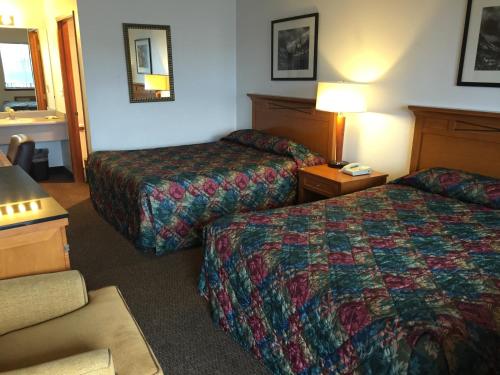 a hotel room with two beds and a couch at Sunshine Motel in Fife