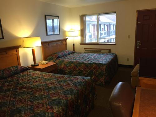 a hotel room with two beds and a window at Sunshine Motel in Fife