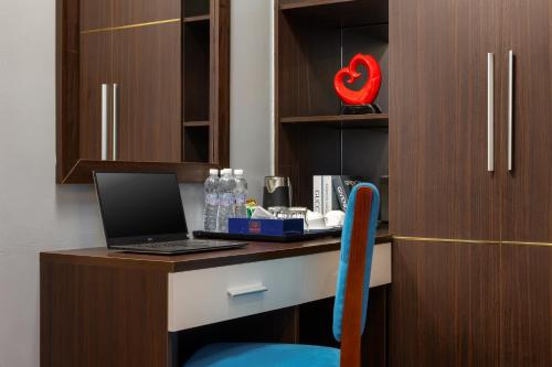 a desk with a laptop computer on top of it at Bendecir Hotel & Spa in Hanoi