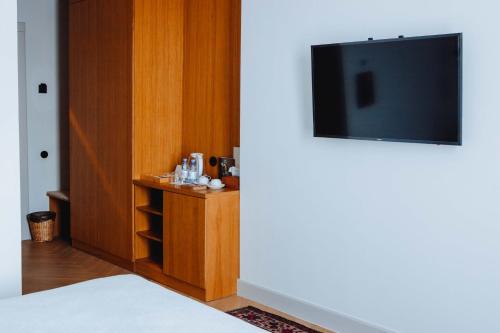 a room with a flat screen tv on a wall at Pana Boutique Hotel in Shymkent