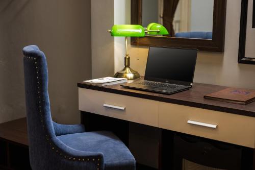 a desk with a laptop computer on top of it at Bendecir Hotel & Spa in Hanoi