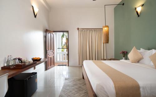 a bedroom with a large bed and a window at The Jungle in Siem Reap