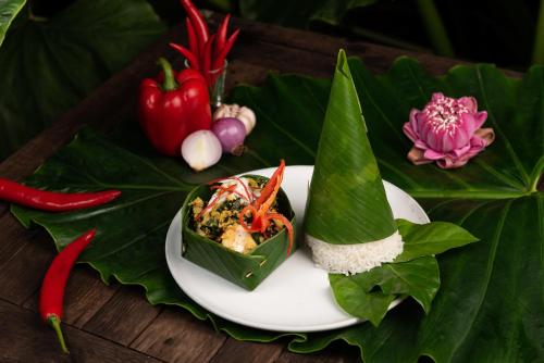 a plate of food with vegetables on a table at The Jungle in Siem Reap