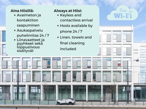 a white building with a car parked in front of it at Hiisi Hotel Helsinki Jätkäsaari in Helsinki