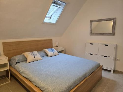 a bedroom with a large bed with a window at SardiniaSeaHouse in Pula