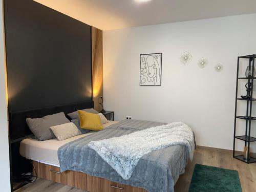 a bedroom with a bed with a black headboard at Alte Schreinerei in Bielefeld
