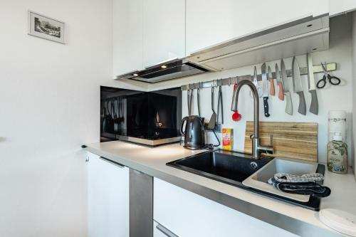a kitchen with a sink and a counter with utensils at Schlossblick in Egloffstein