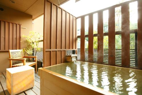 a swimming pool in a room with a large window at Setsugetsuka in Hakone