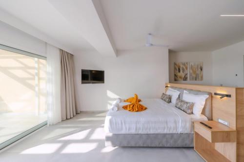 a bedroom with a bed and a large window at Thimios Suites Adults Only in Acharavi