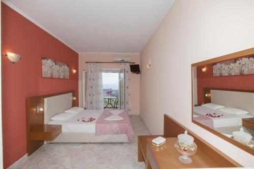 a bedroom with two beds and a mirror at Filoxenia Sea View in Parga