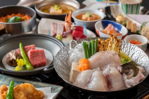 a table topped with plates of food and bowls of food at Setsugetsuka in Hakone