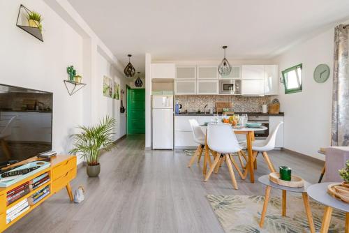 Una cocina y una sala de estar con mesa y sillas. en La Flor Beach, en Puerto de Mogán