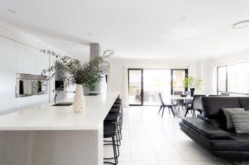 a kitchen and living room with a counter and chairs at Luxury Spacious 5 Bedroom Family Modern Villa Sleeps 10 in Waterford