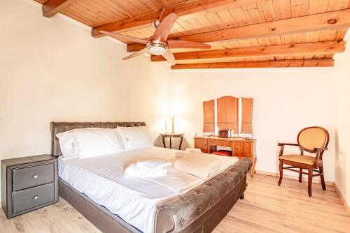 a bedroom with a bed and a wooden ceiling at Traditional Stonehouse in the Village in Megáli Vrísi