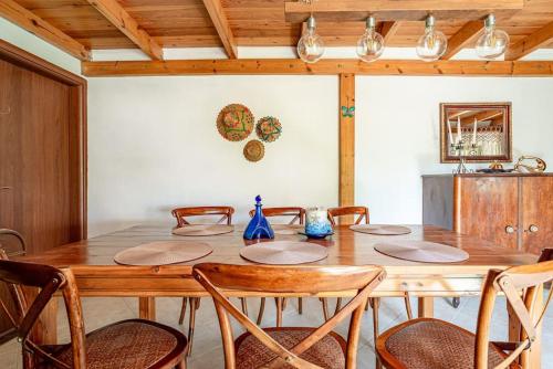 a dining room with a wooden table and chairs at Traditional Stonehouse in the Village in Megáli Vrísi