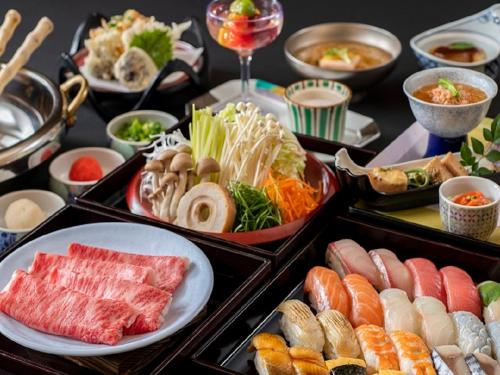 a table filled with different types of sushi and food at Setsugetsuka in Hakone