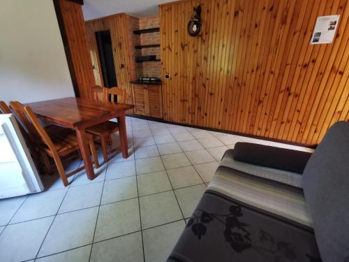 a dining room with a table and a couch at Ośrodek Wypoczynkowy "U Kulasa" in Warchały