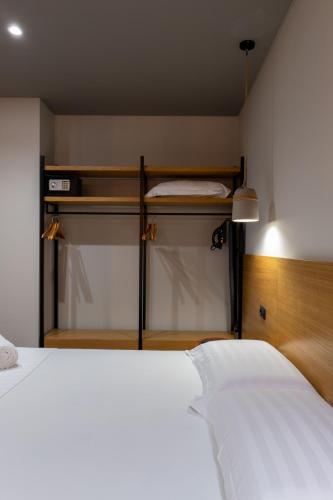 a bedroom with two closets and a white bed at Franklin Rooms in Sarandë